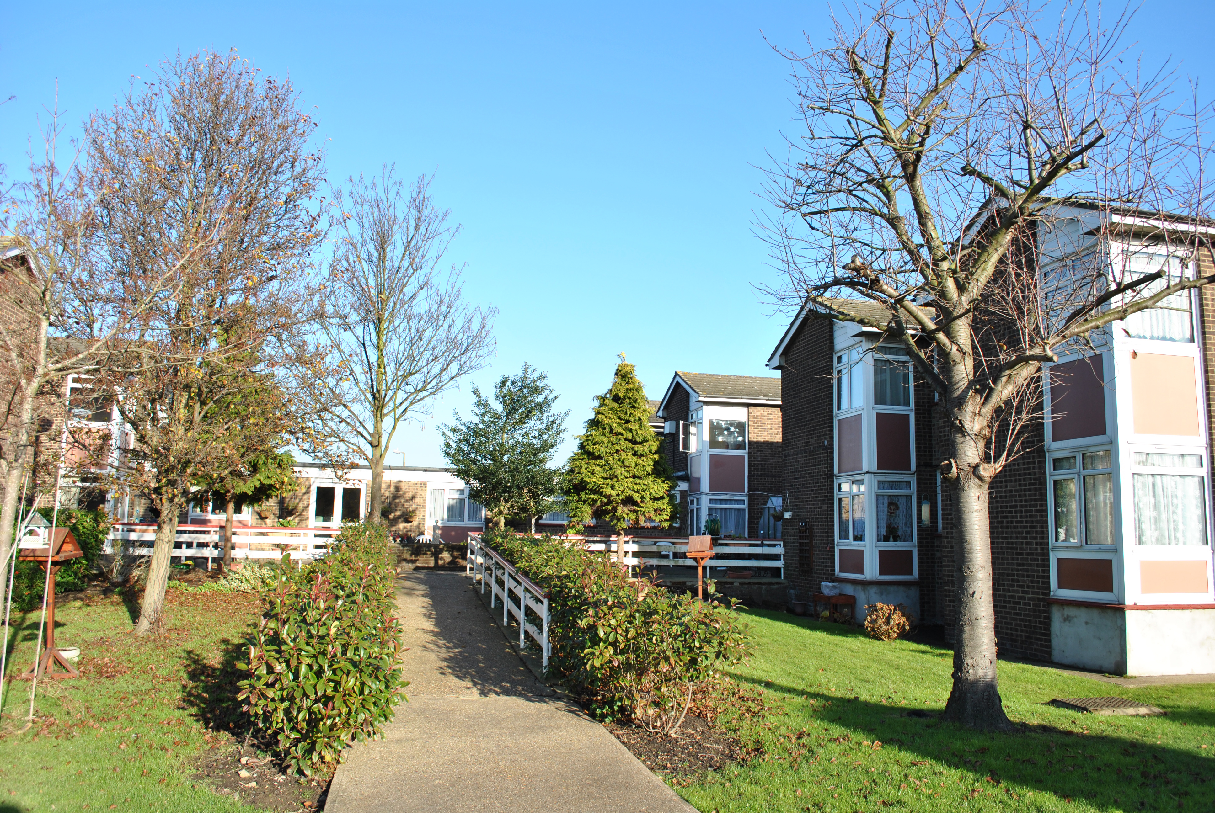 Amelia Blackwell House Exterior. Main ramp leading through trees and hedges to entrance.